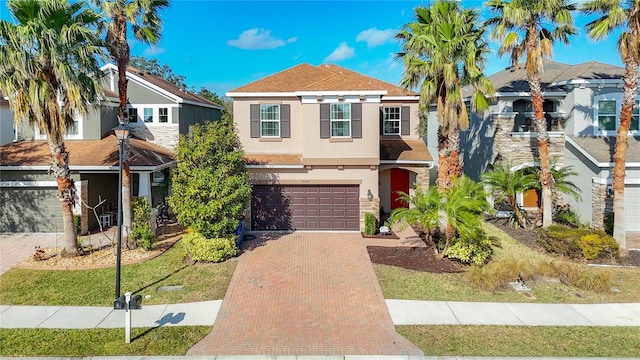 view of front of house featuring a garage and a front yard