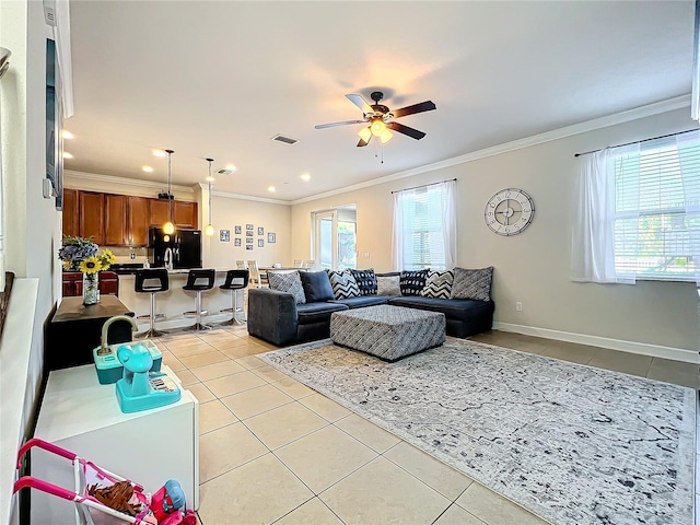 tiled living room featuring ornamental molding and ceiling fan