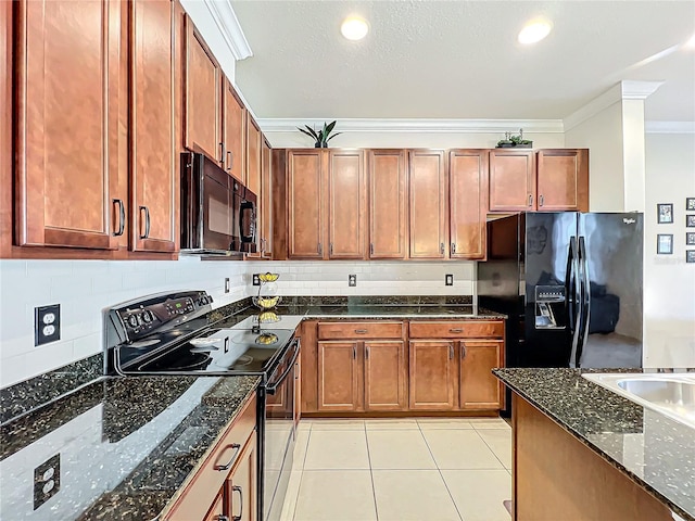 kitchen featuring light tile patterned flooring, tasteful backsplash, dark stone counters, black appliances, and crown molding