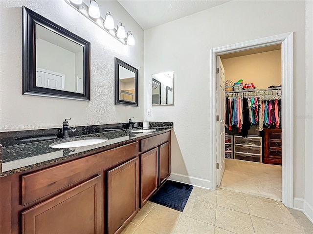 bathroom with tile patterned flooring and vanity