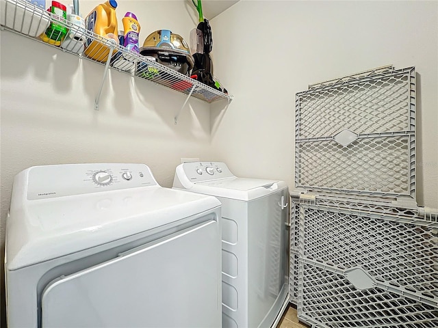 clothes washing area with separate washer and dryer and light tile patterned floors