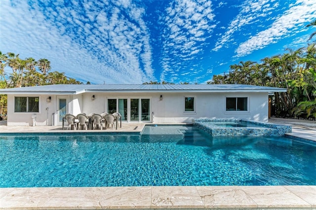 view of pool with a patio and an in ground hot tub