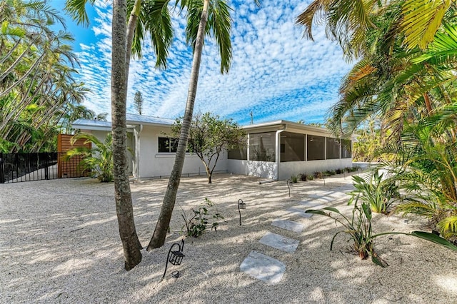 back of house featuring a sunroom