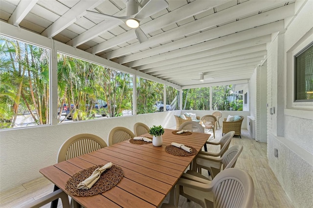 sunroom featuring beamed ceiling and ceiling fan