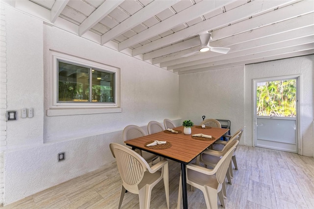 dining room with ceiling fan, beam ceiling, and light wood-type flooring