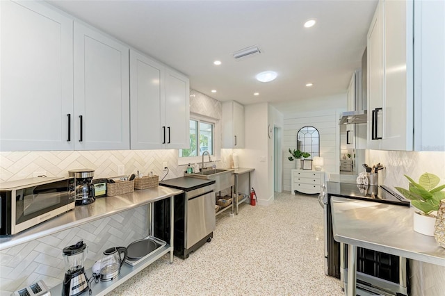 kitchen featuring stainless steel appliances, sink, white cabinets, and decorative backsplash