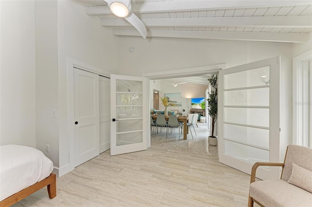 living area featuring light hardwood / wood-style flooring and vaulted ceiling with beams