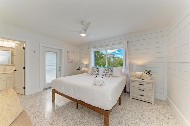 bedroom with connected bathroom, sink, access to outside, and ceiling fan