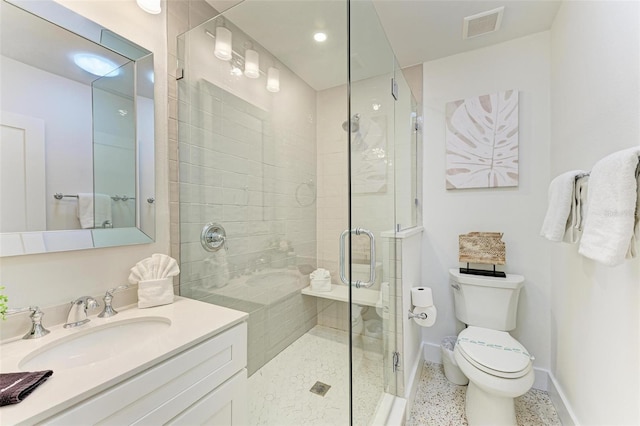 bathroom with vanity, an enclosed shower, and toilet