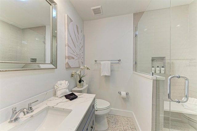 bathroom with vanity, an enclosed shower, and toilet