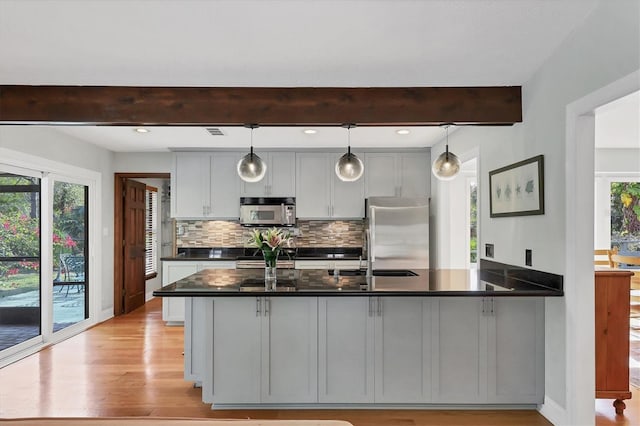 kitchen with gray cabinets, backsplash, stainless steel appliances, decorative light fixtures, and beamed ceiling