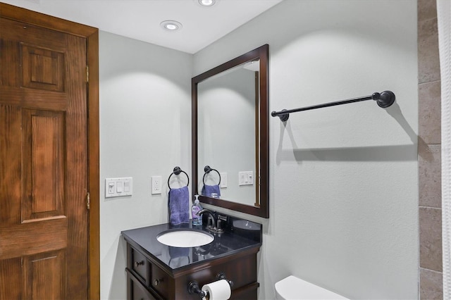 bathroom featuring recessed lighting, vanity, and toilet