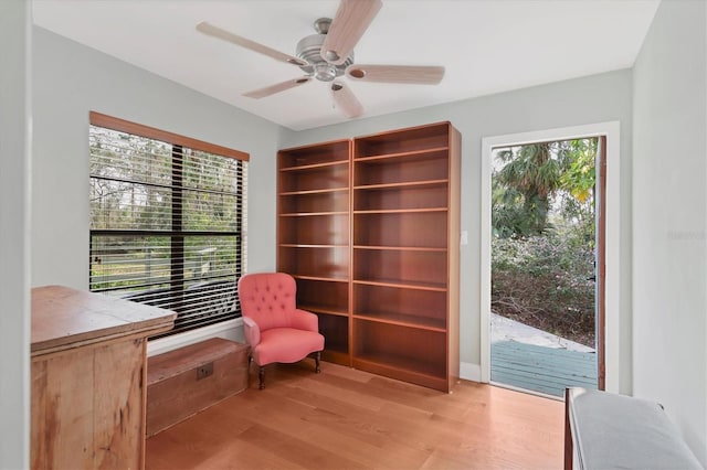 living area with light wood-type flooring and ceiling fan