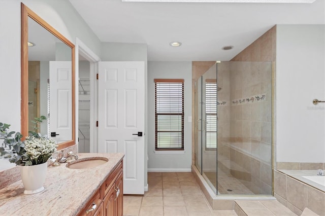 bathroom featuring a bath, a shower stall, vanity, and tile patterned floors