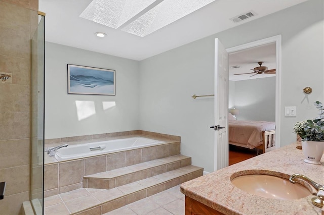 full bathroom featuring a garden tub, a skylight, visible vents, tile patterned floors, and ensuite bath