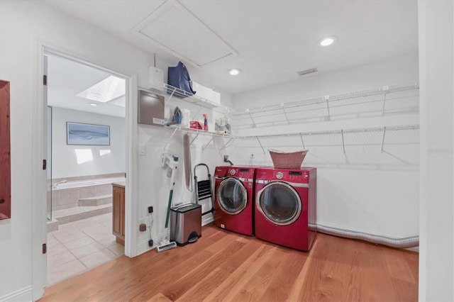 laundry area with laundry area, recessed lighting, light wood-style floors, and washing machine and clothes dryer