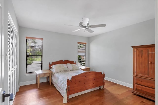 bedroom with ceiling fan and hardwood / wood-style floors