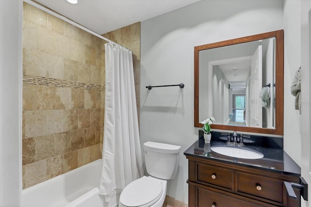 bathroom featuring toilet, shower / bath combo, and vanity