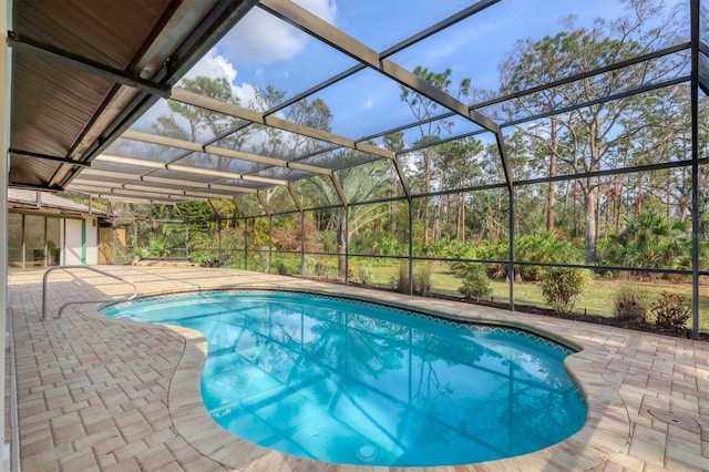 view of pool featuring a lanai and a patio