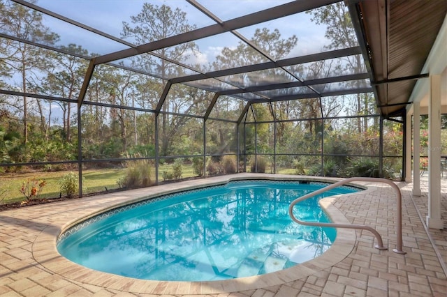 view of swimming pool with a patio and glass enclosure