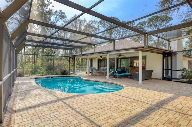 outdoor pool featuring glass enclosure, a patio area, and ceiling fan