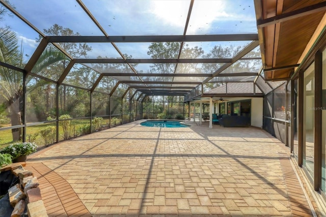 pool with glass enclosure and a patio