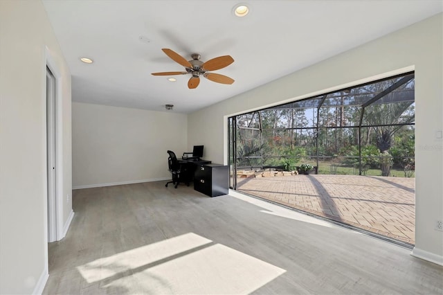 unfurnished office featuring ceiling fan and light wood-type flooring