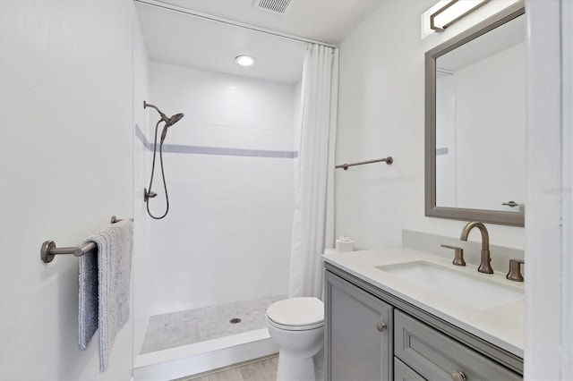 bathroom featuring vanity, a shower with shower curtain, and toilet