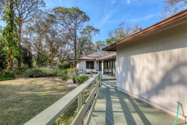 wooden deck with a lawn