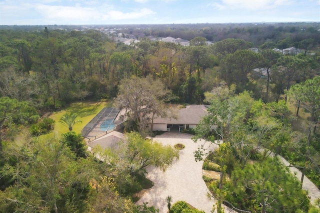 drone / aerial view featuring a forest view