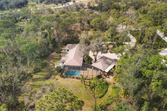 drone / aerial view featuring a wooded view