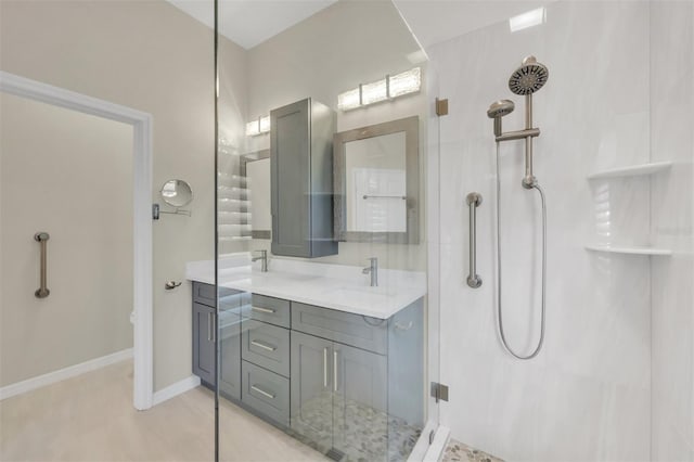 bathroom with walk in shower and vanity