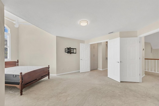 bedroom featuring light carpet