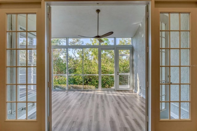 doorway featuring hardwood / wood-style flooring, ceiling fan, and a healthy amount of sunlight