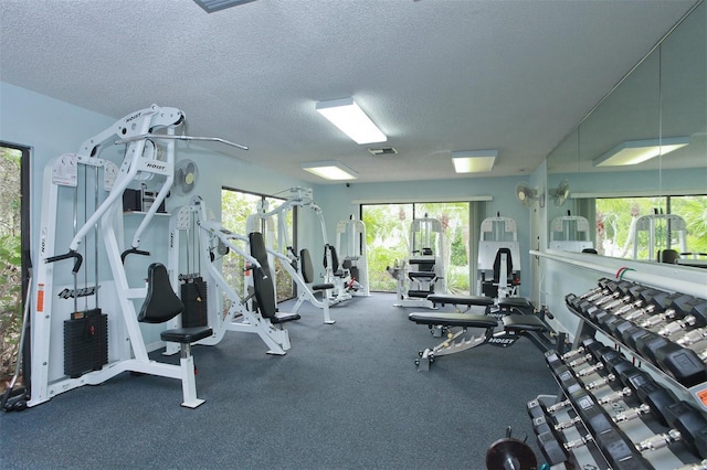 exercise room with a textured ceiling