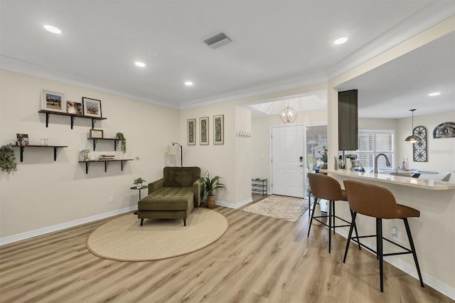 1719 Starling Dr Unit 1719, Sarasota, FL 34231 - sitting room featuring light wood-type flooring, recessed lighting, and crown molding