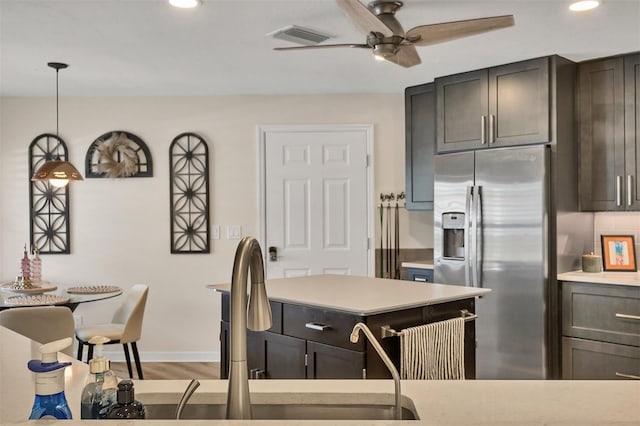 1719 Starling Dr Unit 1719, Sarasota, FL 34231 - kitchen featuring stainless steel fridge, ceiling fan, light countertops, recessed lighting, and pendant lighting