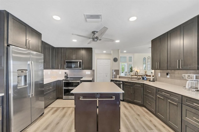 1719 Starling Dr Unit 1719, Sarasota, FL 34231 - kitchen with stainless steel appliances, light wood finished floors, ceiling fan, a kitchen island, and recessed lighting
