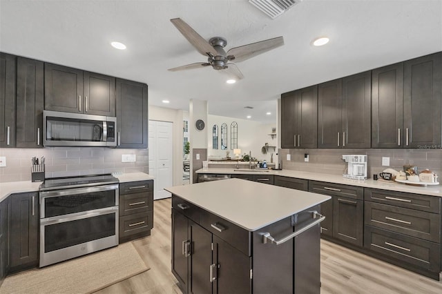 1719 Starling Dr Unit 1719, Sarasota, FL 34231 - kitchen with appliances with stainless steel finishes, light wood-type flooring, light countertops, and recessed lighting