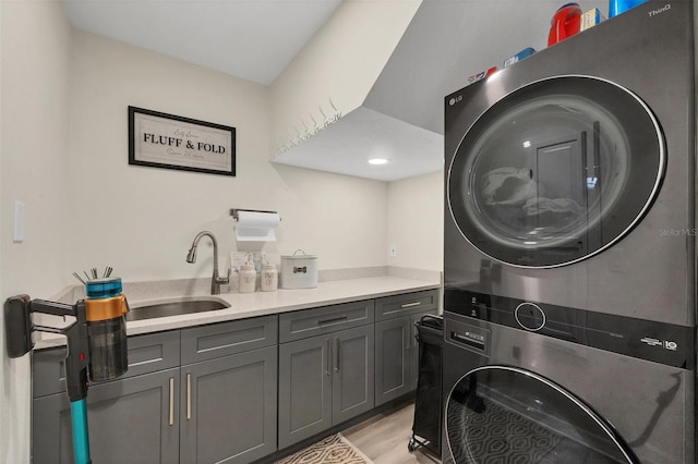 1719 Starling Dr Unit 1719, Sarasota, FL 34231 - laundry area featuring estacked washer and dryer, cabinet space, and light wood finished floors