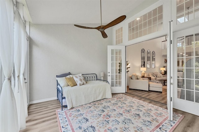 1719 Starling Dr Unit 1719, Sarasota, FL 34231 - bedroom featuring wood finished floors, french doors, a towering ceiling, and ceiling fan