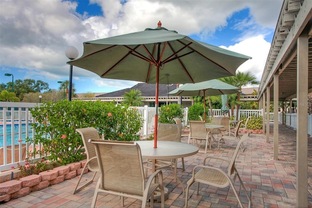 1719 Starling Dr Unit 1719, Sarasota, FL 34231 - view of patio / terrace featuring outdoor dining space and a community pool