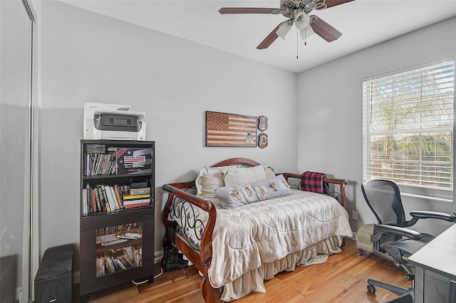 bedroom with wood finished floors and a ceiling fan