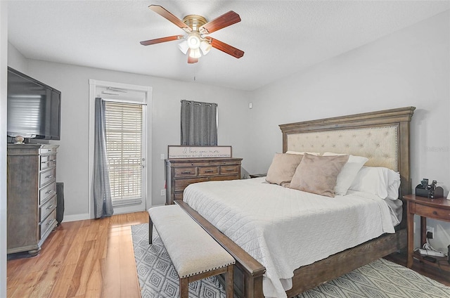 bedroom with access to exterior, baseboards, light wood-style flooring, a textured ceiling, and a ceiling fan