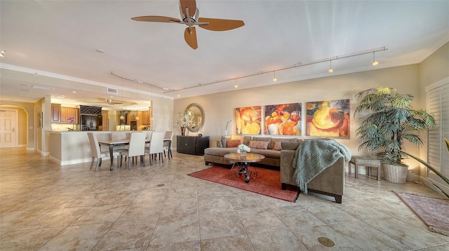 living area featuring arched walkways, light tile patterned floors, visible vents, ceiling fan, and track lighting