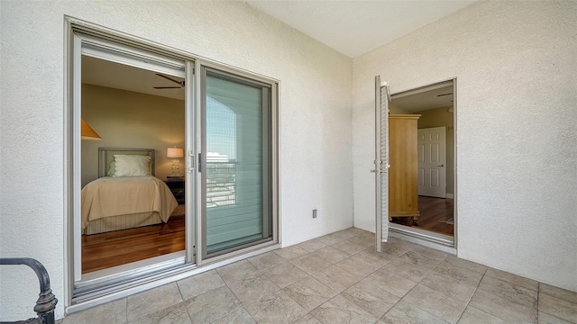 empty room with a ceiling fan and a textured wall