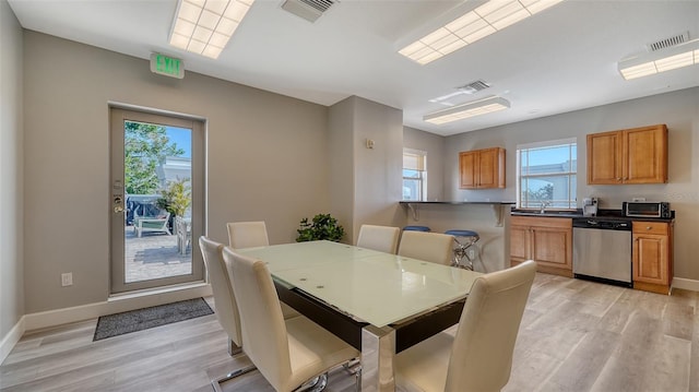 dining room featuring a wealth of natural light, visible vents, and light wood-style floors