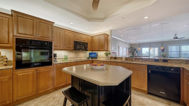 kitchen with brown cabinets, backsplash, a ceiling fan, a sink, and black appliances