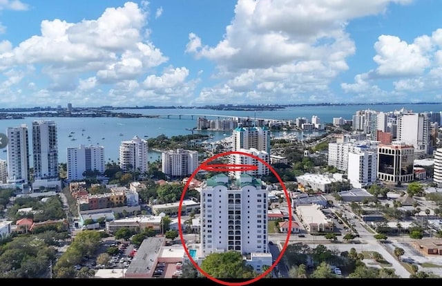 birds eye view of property featuring a water view and a city view