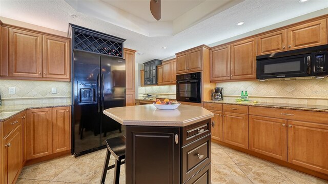 505 S Orange Ave Unit 501, Sarasota, FL 34236 - kitchen with black appliances, tasteful backsplash, brown cabinets, and recessed lighting